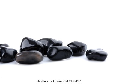 Black onyx pile isolated on white background