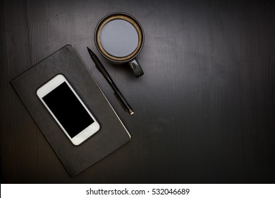 Black organizer or book on a table with cup coffee and smartphone - Powered by Shutterstock