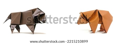 Black origami bull standing opposite of a brown origami bear on a white background depicting Wall street  sentiments.