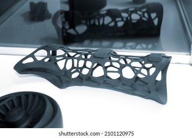 Black orthopedic plastic prosthesis printed on powder 3D printer for hand. Orthopedic gypsum helmet close-up. Multi Jet Fusion MJF 3D printing technology. New modern progressive additive technology.