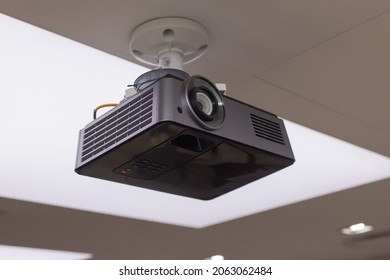 A Black Overhead Projector On Ceiling In A Conference Room Modern Classroom Color Toned Image.