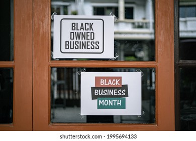 Black Owned Business And Black Business Month Sign Were Attached On The Window