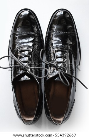 Black oxford shoes isolated on white background, patent leather shoes closeup
