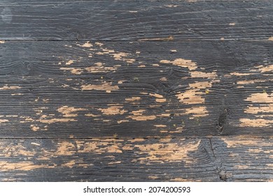 Black paint peeled off on old wood planks revealing the light color of the wood. Reference material for artists.