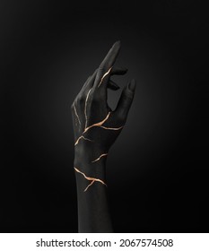 black painted and patterned hand on black ground