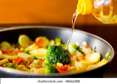 black pan with different vegetables and oil