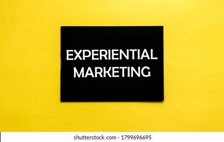 black pancel write a text Experiential Marketing on the yellow