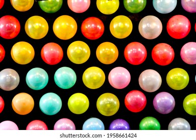 Black panel with colored balloons in a row texture in a fair