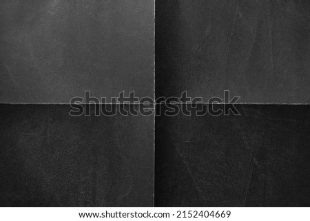 Black paper background with creases that separates paper symmetrically into four parts Foto stock © 