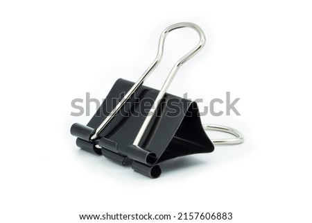 Black paper clip close up isolated  on a white background.