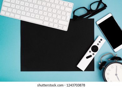 black paper copyspace with computer keyboard, glasses, smartphone and clock. topview, copy space
