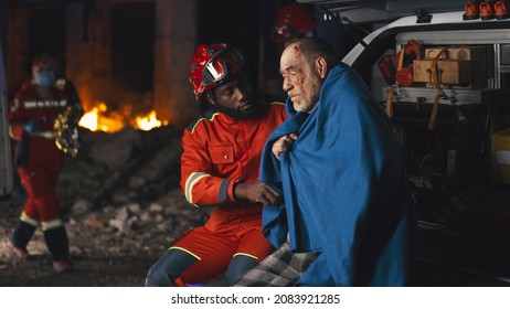 Black Paramedic Speaking With Survivor