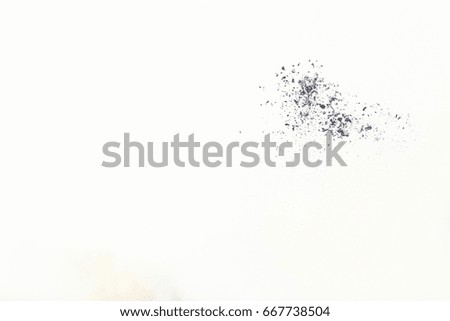 Black particles explosion isolated on white background. Abstract dust overlay texture.