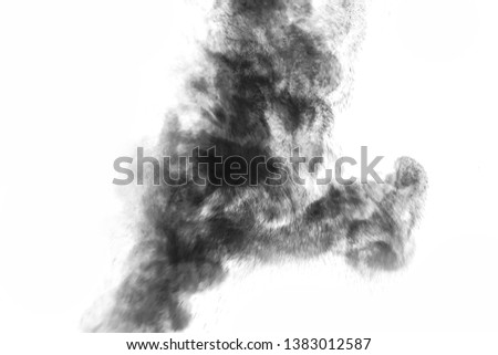 Black particles splatter on white background. Black powder dust burst. 
