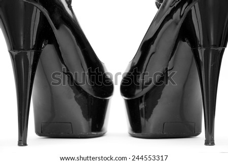 black patent female shoes on a white background
