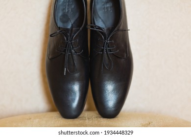 Black patent leather men's boots close up