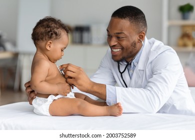 Black Pediatrician Doctor Doing Check Up To Cute Newborn Baby In Diaper, African American Pediatrist Using Stethoscope For Listening Child's Heartbeat, Checking Infant's Heart And Lungs In Clinic - Shutterstock ID 2003752589