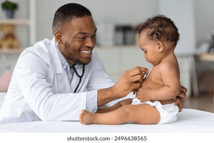 Black Pediatrician Doctor Doing Check Up To Cute Newborn Baby In Diaper, African American Pediatrist Using Stethoscope For Listening Child's Heartbeat, Checking Infant's Heart And Lungs In Clinic - Powered by Shutterstock