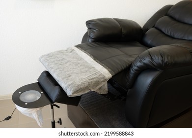 Black Pedicure Chair With Dust Vacuum Cleaner In Beauty Salon. 