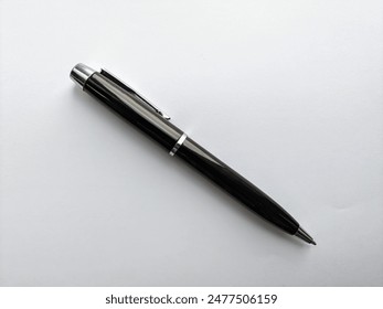 a black pen isolated on the white paper background 