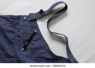 A Black Pen On A Denim Apron