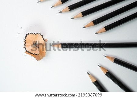 Black pencil and pencil shavings surround by group of black pencil with white background, School concept, Painting and education concepts.