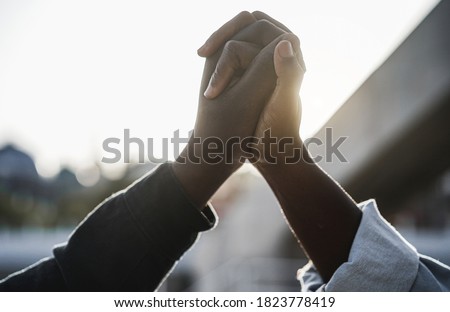 Black people holding hands during protest for no racism