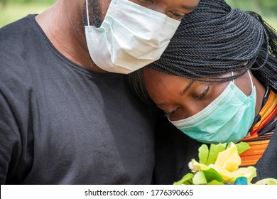 black people mourning lost ones to coronavirus, wearing face masks, showing support for each other