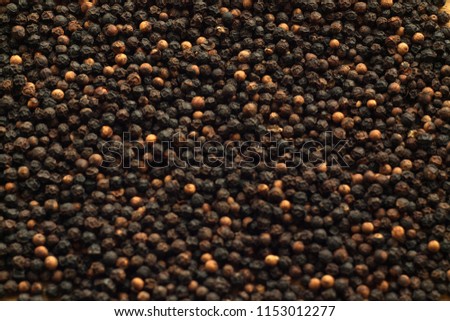 Black pepper close-up with blur effect. Abstract background and texture for design.