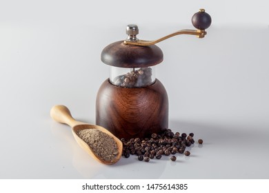 Black Pepper And Pepper Grinder On A White Background