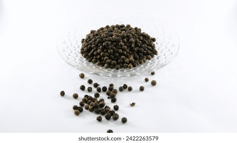 Black Pepper: Tiny spheres of aromatic potency. A staple spice, adding depth and warmth to culinary creations with its rich, earthy flavor. - Powered by Shutterstock