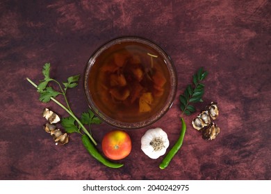 Black Pepper And Tomato Rasam Or Clear Soup In Indian Style, South Indian Food Recipe Called Rasam .  Medicine For Coughing, Running Nose And Flu. Rasam In Isolated White Background With Ingredient.