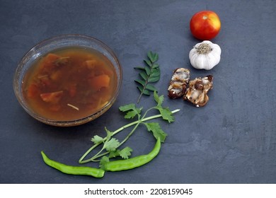 Black Pepper And Tomato Rasam Or Clear Soup In Indian Style, South Indian Food Recipe Called Rasam .  Medicine For Coughing, Running Nose And Flu. Rasam In Isolated White Background With Ingredient