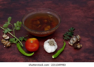 Black Pepper And Tomato Rasam Or Clear Soup In Indian Style, South Indian Food Recipe Called Rasam .  Medicine For Coughing, Running Nose And Flu. Rasam In Isolated White Background With Ingredient