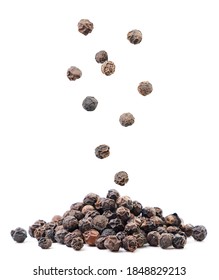 Black Peppercorns Falling On A Pile On A White Background. Isolated