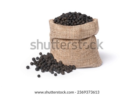 Black peppercorns (Black pepper) seeds in burlap sack bag isolated on white background.
