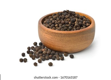 Black peppercorns (Black pepper) in wooden bowl isolated on white background.