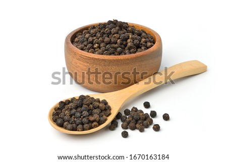 Black peppercorns (Black pepper) in wooden bowl isolated on white background.