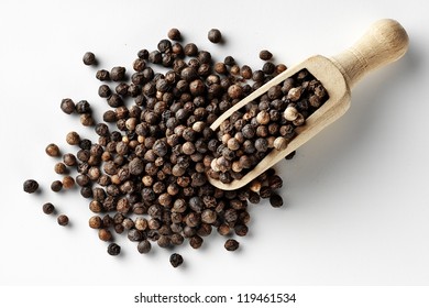 Black Peppercorns In Wooden Spoon Isolated