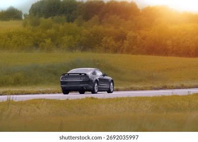 Black performance car on empty highway