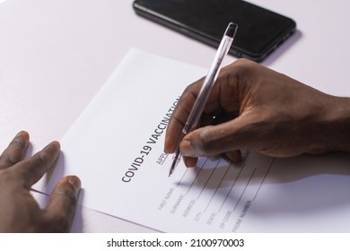 Black Person Filling A Covid-19 Vaccination Form