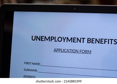 Black Person Filling Unemployment Benefit Form On A Computer