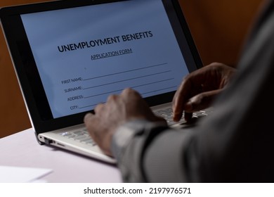 Black Person Filling Unemployment Benefit Form On A Computer