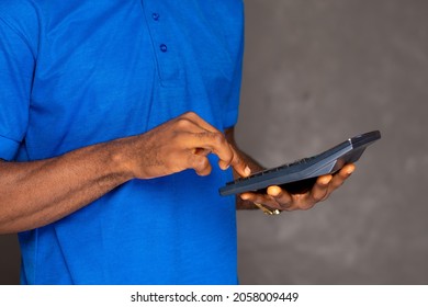 Black Person Using A Calculator Close Up