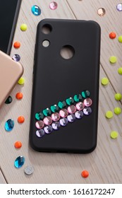 Black Phone Case Decorated With Colorful Rhinestone Stripes. Glamorous Phone Accessory DIY Project.