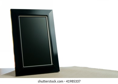 Black Photoframe On The Table In White Background