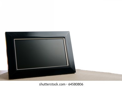 Black Photoframe On The Table In White Background