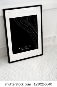 Black picture frame mockup on the floor