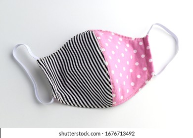 Black And Pink Design Of Face Mask Handmade From Fashion Fabric Cloth Isolated On White Background