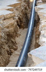 black pipe on the trench during the road works in the city